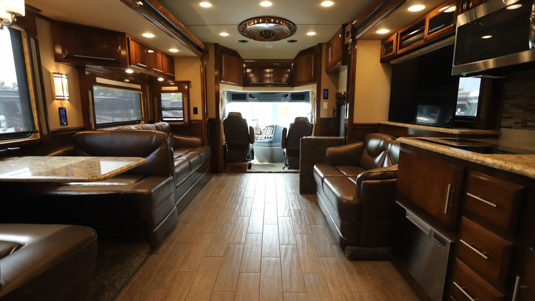 Luxury RV living area with leather sofas and wood-plank flooring