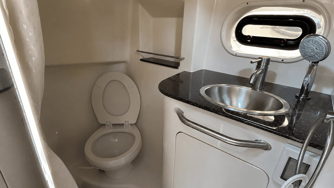 Compact boat head with marine toilet and sink