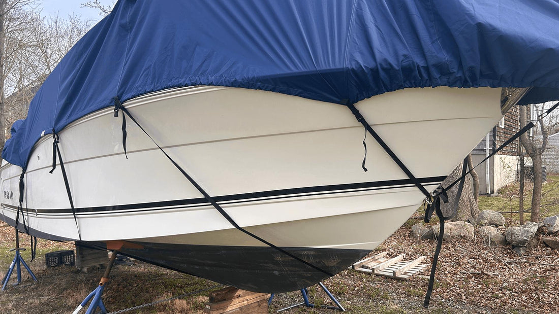 Boat under cover in yard after winter storage