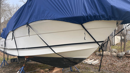 Boat under cover in yard after winter storage