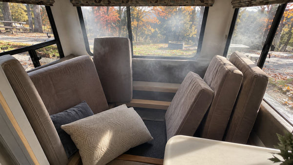 RV cabin with cushions propped up and haze in the air