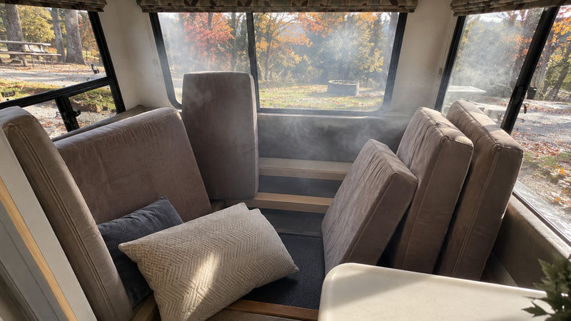 RV cabin with cushions propped up and haze in the air