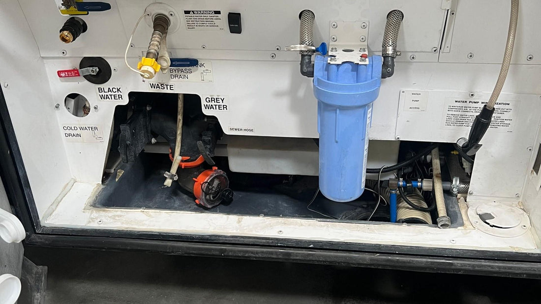 RV utility bay with black water, grey water, and waste hose connections
