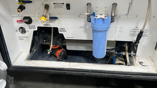 RV utility bay with black water, grey water, and waste hose connections